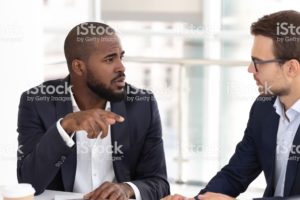 Two men having a difficult conversation in the workplace.